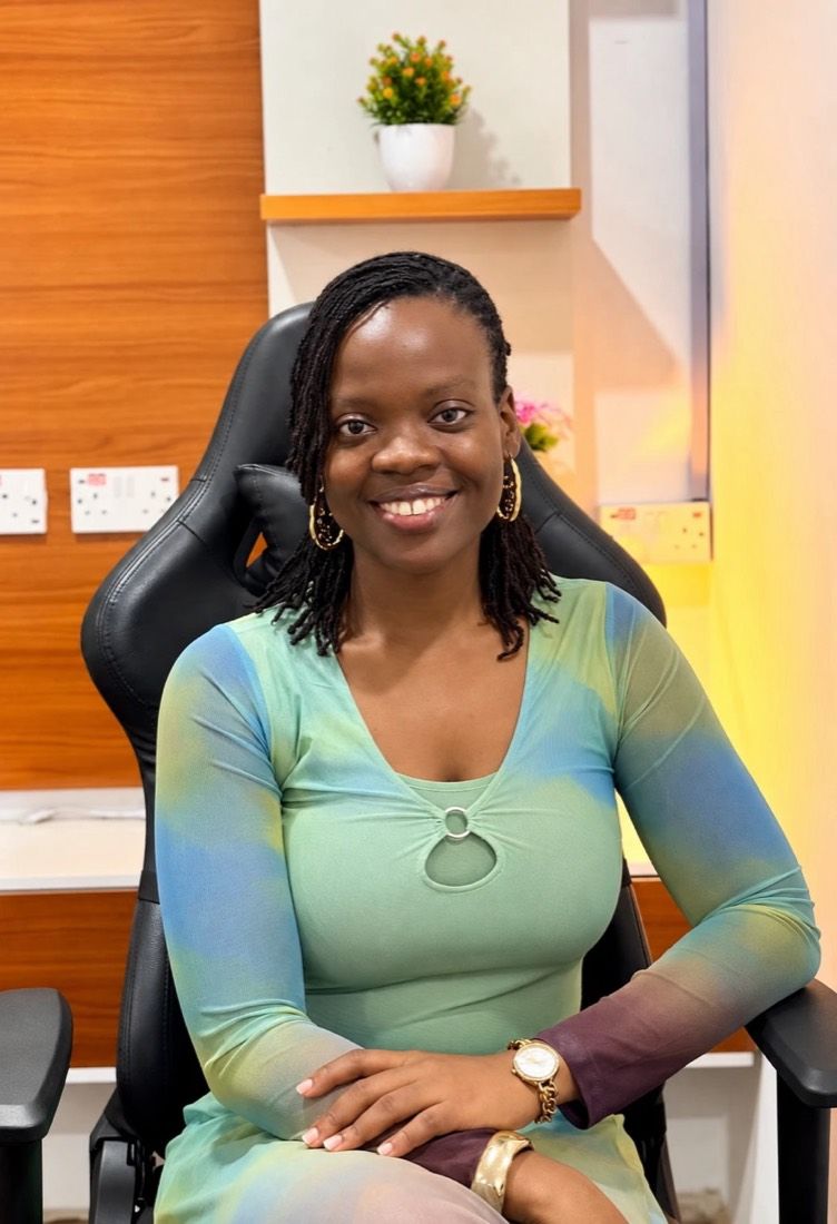 Nana-Fatimah smiling, seated in her studio chair